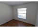 Bedroom featuring wood-look floors and window at 1122 Montrose Pl # 1713, Dunedin, FL 34698