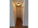 Bright hallway with clean white walls and wood-look flooring leading to various rooms in the home at 1122 Montrose Pl # 1713, Dunedin, FL 34698