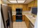 Kitchen featuring stainless steel appliances and ample cabinet space at 1122 Montrose Pl # 1713, Dunedin, FL 34698