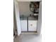 Convenient laundry room featuring a washer, dryer, and water heater inside with louvered doors at 1122 Montrose Pl # 1713, Dunedin, FL 34698