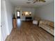 Living room featuring wood-look floors and plenty of natural light at 1122 Montrose Pl # 1713, Dunedin, FL 34698