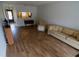 Living room featuring wood-look floors and plenty of space at 1122 Montrose Pl # 1713, Dunedin, FL 34698