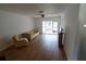 Living room featuring wood-look floors and a sliding glass door at 1122 Montrose Pl # 1713, Dunedin, FL 34698