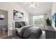 A well-lit bedroom featuring a king-size bed and a ceiling fan at 11622 Colony Lake Dr, Tampa, FL 33635