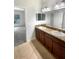 Bathroom featuring double sinks, granite countertops, and tile flooring at 37601 Georgina Ter, Zephyrhills, FL 33542