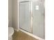 Bathroom with glass shower door, tile flooring and walls at 37601 Georgina Ter, Zephyrhills, FL 33542
