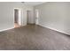 Spacious bedroom featuring carpet flooring and multiple doorway entrances at 37601 Georgina Ter, Zephyrhills, FL 33542
