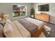 Cozy bedroom with natural light, a sleek TV set, and modern decor, creating a relaxing atmosphere at 37601 Georgina Ter, Zephyrhills, FL 33542