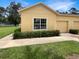 Cozy home with attached garage, well-manicured landscaping, and inviting curb appeal at 37601 Georgina Ter, Zephyrhills, FL 33542