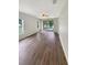 Spacious living room featuring hardwood floors and sliding glass doors to the outside at 37601 Georgina Ter, Zephyrhills, FL 33542
