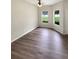 A bright living room showcasing modern flooring, neutral paint, and natural light at 37601 Georgina Ter, Zephyrhills, FL 33542