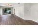Spacious living room featuring wood floors and a sliding glass door to the backyard at 37601 Georgina Ter, Zephyrhills, FL 33542