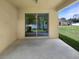 Covered patio features a sliding glass door leading to a spacious and well-maintained backyard at 37601 Georgina Ter, Zephyrhills, FL 33542