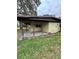 Features a covered back porch, providing an outdoor living space with a concrete base and wood supports at 5026 Osprey Ln, New Port Richey, FL 34652