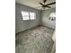 An empty bedroom with a window and ceiling fan, offering a blank canvas for personalization at 5026 Osprey Ln, New Port Richey, FL 34652