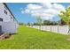 Large, grassy backyard with a fence at 7292 Deer Valley Circle, Tampa, FL 33635