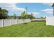 Spacious backyard with lush green grass and a tall white privacy fence at 7292 Deer Valley Circle, Tampa, FL 33635