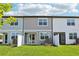 Townhome backyard featuring a well-maintained lawn, privacy fences and sliding glass doors at 7292 Deer Valley Circle, Tampa, FL 33635