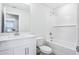 Bright white bathroom with a shower and tub combination and a vanity at 7292 Deer Valley Circle, Tampa, FL 33635