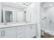 Bright bathroom with double vanity, white cabinets, quartz countertops, and a glass-enclosed shower at 7292 Deer Valley Circle, Tampa, FL 33635