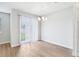 Bright dining room with wood-look tile floors and sliding glass door to the outdoor area at 7292 Deer Valley Circle, Tampa, FL 33635