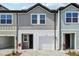 Charming two-story townhome with a one-car garage and neutral gray siding at 7292 Deer Valley Circle, Tampa, FL 33635