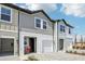 Exterior view of a townhome featuring stone pavers, one-car garage, and well-kept landscaping at 7292 Deer Valley Circle, Tampa, FL 33635