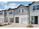 A quaint townhome featuring a one-car garage, brick paver driveway, and well-maintained landscape at 7292 Deer Valley Circle, Tampa, FL 33635