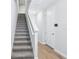 Bright entryway featuring a staircase, wood-look tile, and neutral paint at 7292 Deer Valley Circle, Tampa, FL 33635