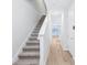 Bright hallway featuring wood-look tile floors, a staircase, and neutral paint at 7292 Deer Valley Circle, Tampa, FL 33635