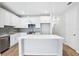 Modern kitchen with white cabinetry, gray backsplash, and stainless steel appliances at 7292 Deer Valley Circle, Tampa, FL 33635