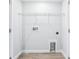 Convenient laundry room featuring wood-look flooring and wire shelving above at 7292 Deer Valley Circle, Tampa, FL 33635