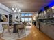 Open-concept dining area with stylish light fixtures, hardwood floors and ocean view at 19700 Gulf Blvd # 204, Indian Shores, FL 33785