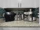 Kitchen countertop with stainless steel appliances and white cabinetry at 19700 Gulf Blvd # 204, Indian Shores, FL 33785