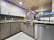 Modern kitchen featuring stainless steel appliances and views of the home's living spaces at 19700 Gulf Blvd # 204, Indian Shores, FL 33785