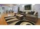 Spacious living room featuring a large sectional sofa, a patterned rug, and access to the kitchen at 19700 Gulf Blvd # 204, Indian Shores, FL 33785