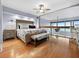 Bright main bedroom with hardwood floors, ceiling fan, and ocean view at 19700 Gulf Blvd # 204, Indian Shores, FL 33785