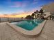 Beautiful pool area with palm trees and ocean views at sunset at 19700 Gulf Blvd # 204, Indian Shores, FL 33785