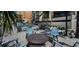 Inviting pool area with fire pit and comfortable seating, surrounded by lush landscaping at 19700 Gulf Blvd # 204, Indian Shores, FL 33785