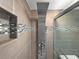 Shower featuring multi-setting shower head, decorative tile and corner niche at 19700 Gulf Blvd # 204, Indian Shores, FL 33785