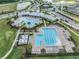 Stunning aerial view of the community pool, roundabout and lush landscaping at 2913 Suncoast Plains Dr, Odessa, FL 33556