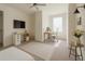 Bright bedroom with a dedicated office, window, and neutral carpet at 2913 Suncoast Plains Dr, Odessa, FL 33556
