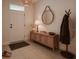 Bright entryway with decorative elements, a woven pendant light, and neutral wall tones at 2913 Suncoast Plains Dr, Odessa, FL 33556