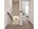 A view of the upstairs hallway with neutral paint, carpet, and a bedroom suite visible through a doorway at 2913 Suncoast Plains Dr, Odessa, FL 33556