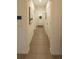 Neutrally decorated hallway leading to the front door and featuring tiled floors at 2913 Suncoast Plains Dr, Odessa, FL 33556