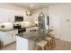Modern kitchen with stainless steel appliances, a stone countertop island, and sleek white cabinetry at 2913 Suncoast Plains Dr, Odessa, FL 33556