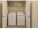 Laundry closet with a side-by-side washer and dryer and a shelf for storage at 2913 Suncoast Plains Dr, Odessa, FL 33556