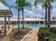 Community pool with lush landscaping, perfect for relaxing and socializing with neighbors at 2913 Suncoast Plains Dr, Odessa, FL 33556