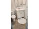 Cozy bathroom with toilet, vanity, a bright mirror, and tile floors at 6600 121St Ave # 5, Largo, FL 33773