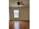 Bedroom with wood floors, a ceiling fan and large window allowing natural light at 6600 121St Ave # 5, Largo, FL 33773